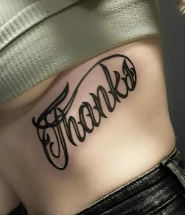 female black lettering 纹身 在 ribcage #49709 | 纹身师 Владимир GLOK
