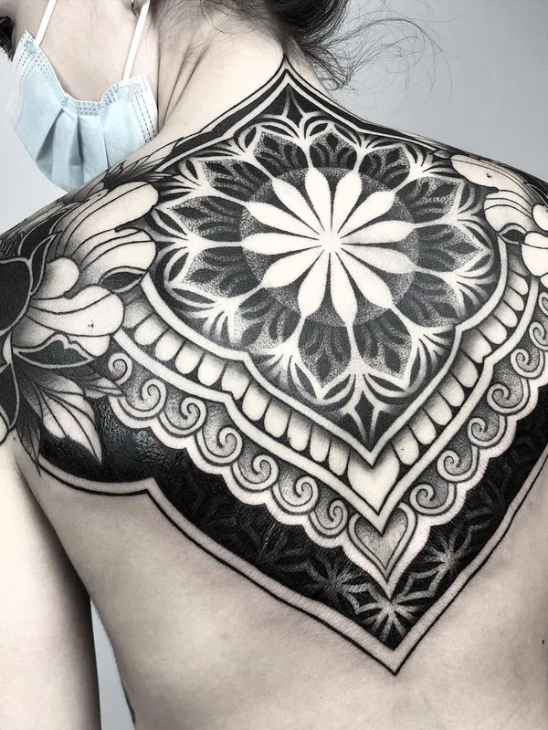 female black and grey ornamental tattoo on upper back #55565 | Tattoo Artist Raimundo Ramírez