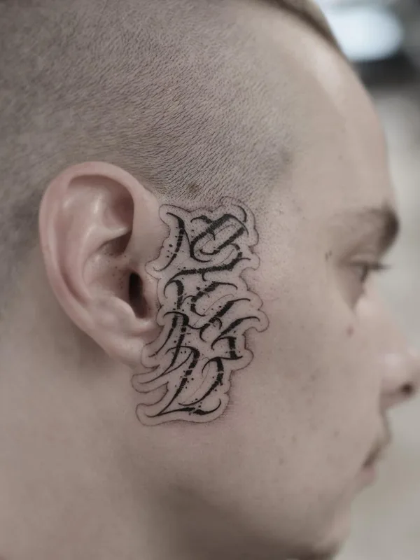 male black lettering 纹身 在 face #41587 | 纹身师 Niorkz