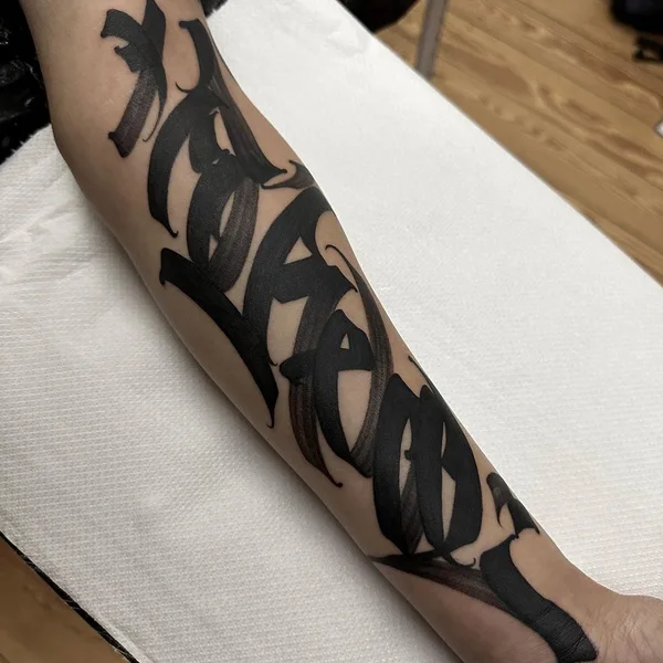 Calligraphy tattoo by Dustin | DESUR in Hamburg