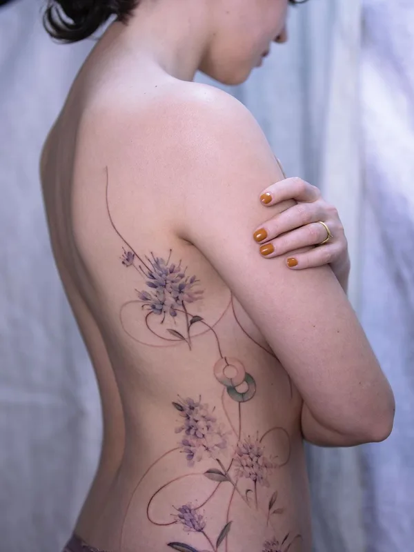 female color botanic tattoo on side #46242 | Tattoo Artist Sion