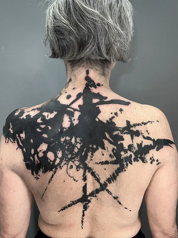 black blackout tattoo on upper back #46422 | Tattoo Artist El Cuero Miller 
