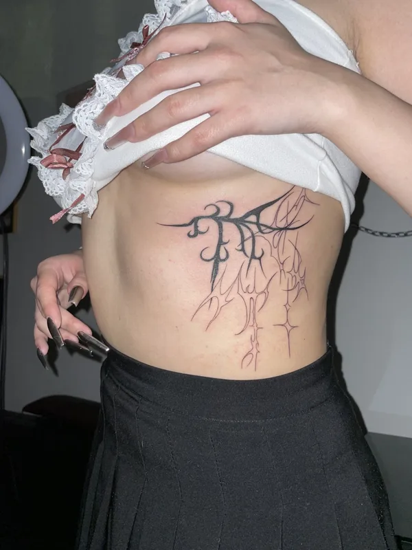 female black linework tattoo on ribcage #87138 | Tattoo Artist Ольга Глотова 