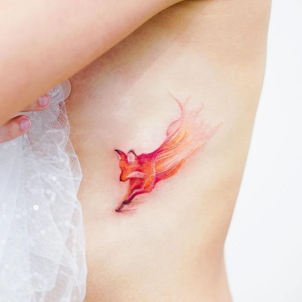 Watercolor Fox tattoo on Ribcage