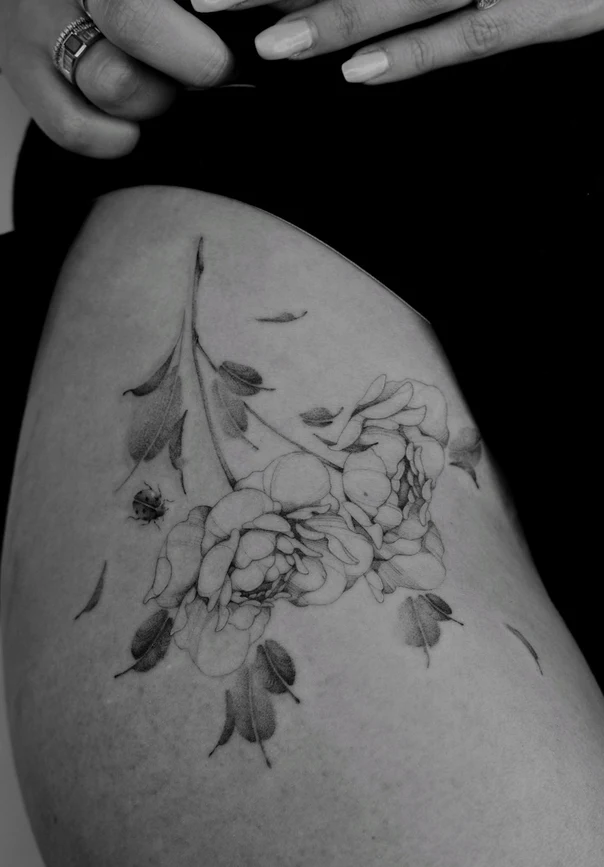 Fineline Flowers, Ladybug tattoo on Thigh