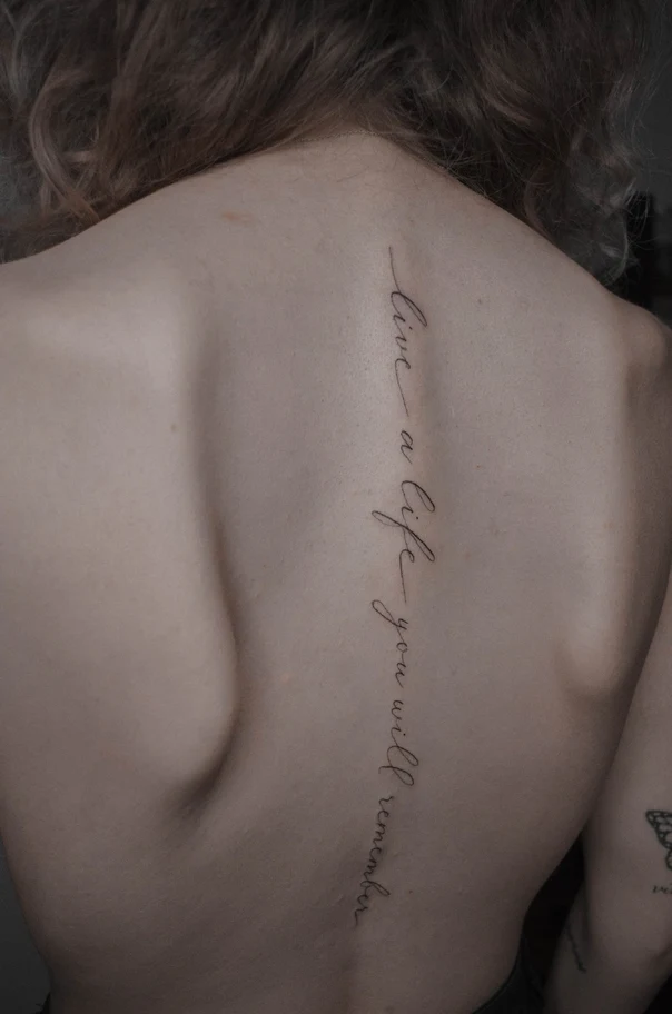 Calligraphy tattoo on Spine