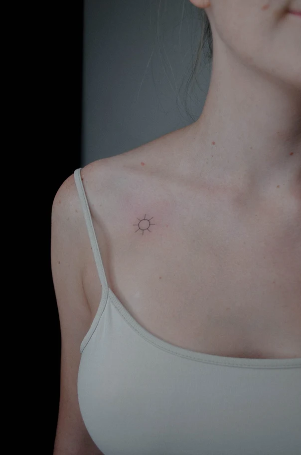 Linework Sun tattoo on Collarbone