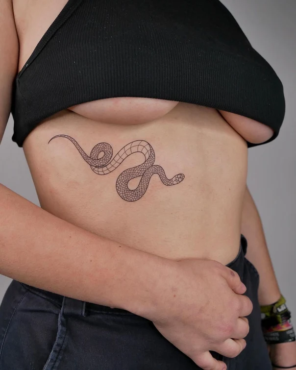 Linework Snake tattoo on Ribcage