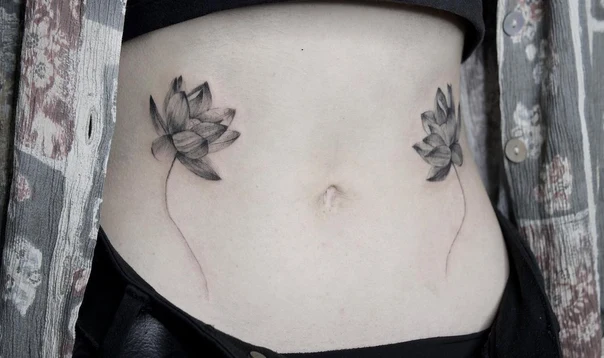 Fineline Lotus tattoo on Stomach