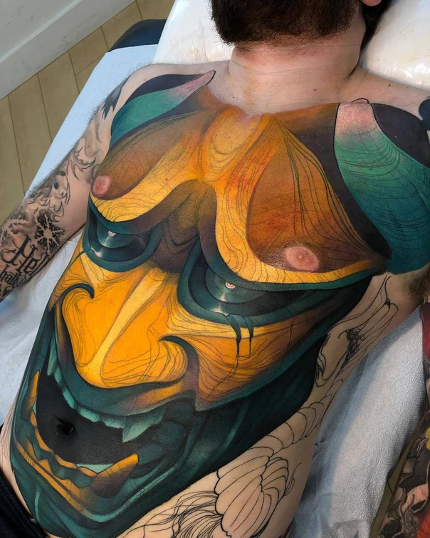 Abstract Mask tattoo on Chest