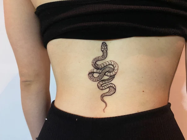 Linework Snake tattoo on Ribcage