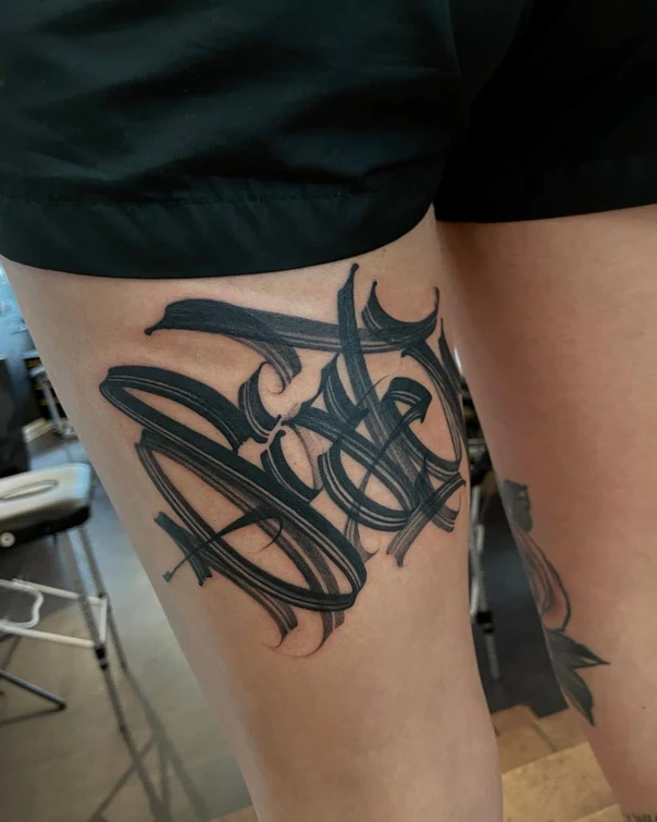 Calligraphy Lettering tattoo on Thigh