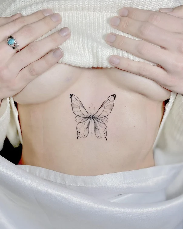 Fineline Butterfly tattoo on Sternum