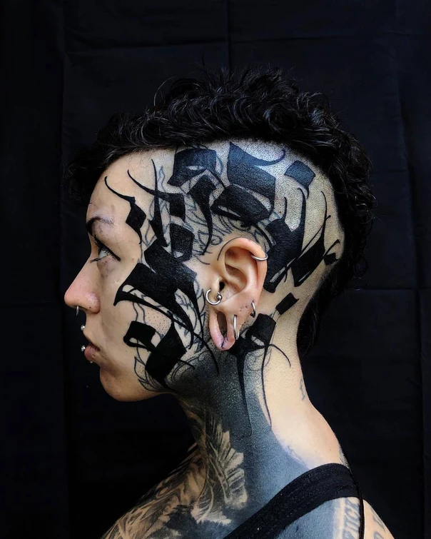 Blackwork Calligraphy tattoo on Face