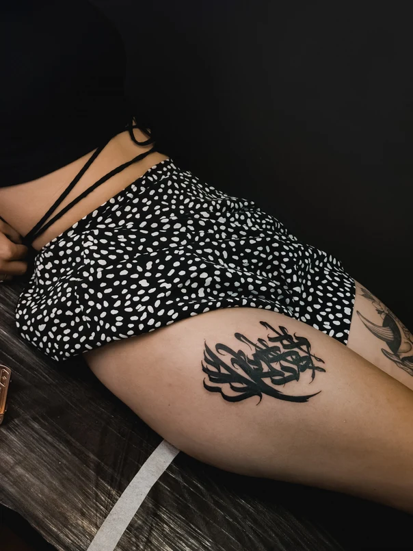 Calligraphy Abstract tattoo on Thigh