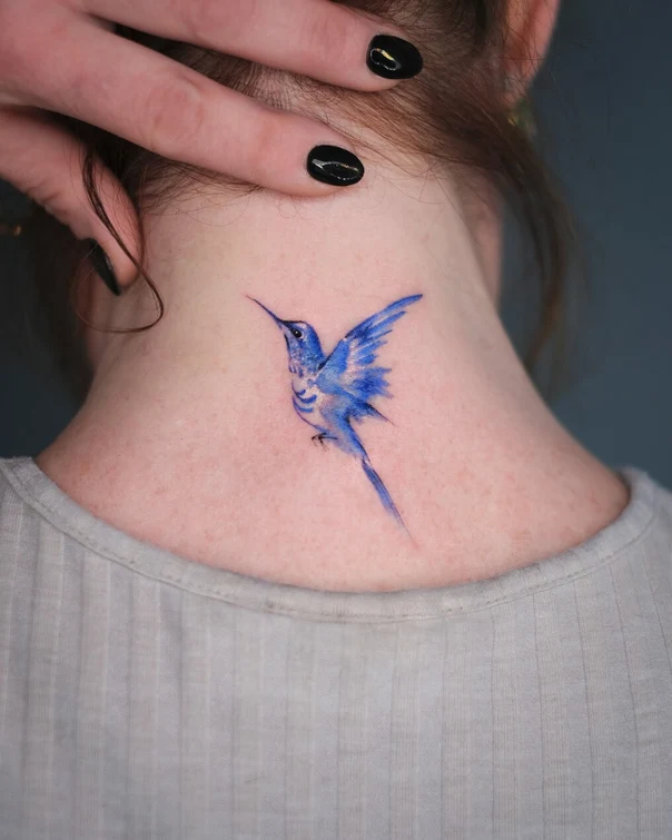 Watercolor Bird tattoo on Back of neck