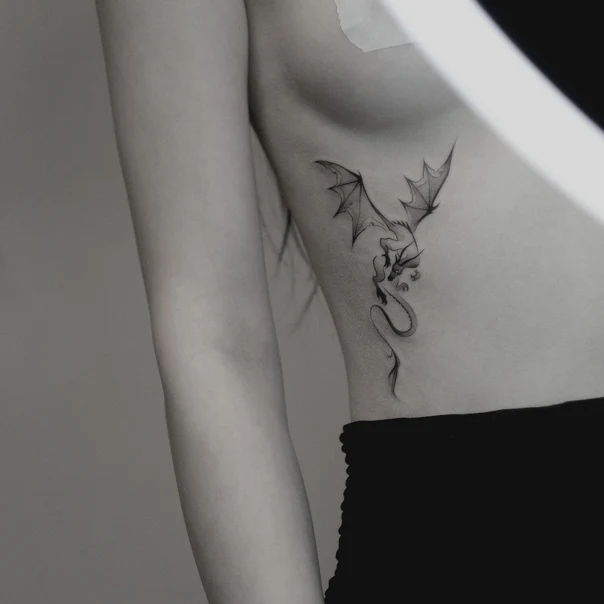Fineline Dragon tattoo on Ribcage
