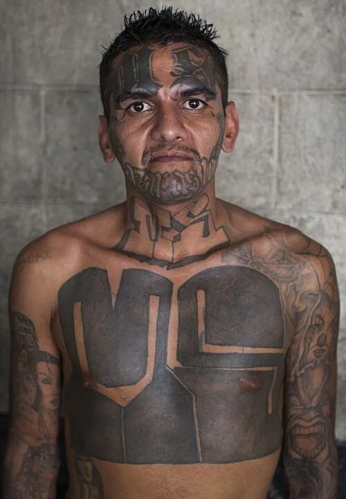 An MS-13 gang member with tattoos on his face and chest, including the abbreviation "MS" and other symbols indicating gang affiliation. Photo: nevsedoma.com.ua (CC BY-SA 2.0).