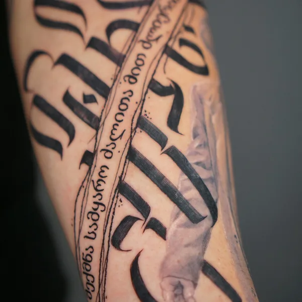 Calligraphy tattoo by Nikita Presnyakov in Tbilisi