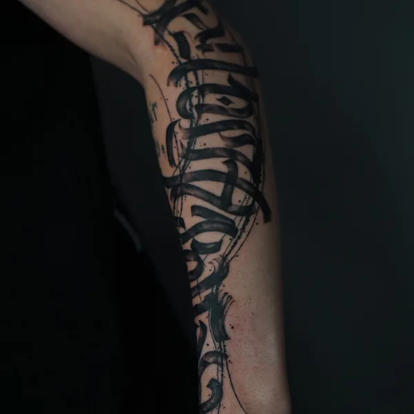 Calligraphy tattoo by Nikita Presnyakov in Tbilisi