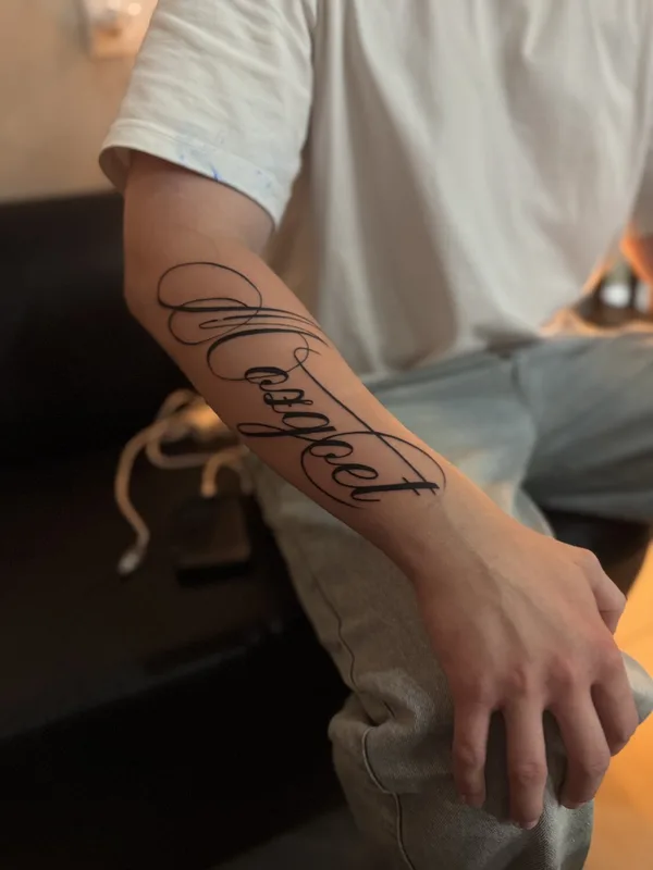 black lettering tattoo on forearm #98968 | Tattoo Artist julia wzertis