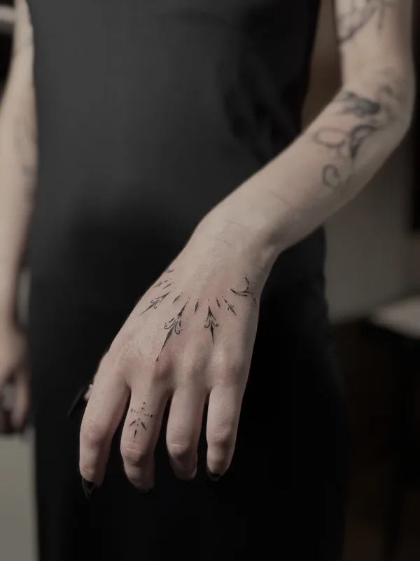 female black fineline tattoo on back of hand #101168 | Tattoo Artist julia wzertis