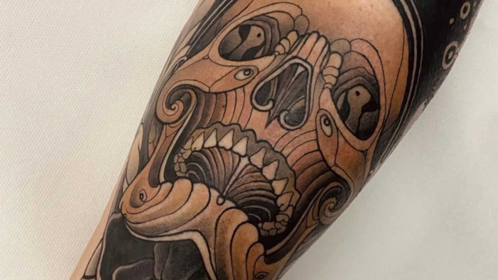 Neo-traditional tattoos in a discreet palette by Georg Faust