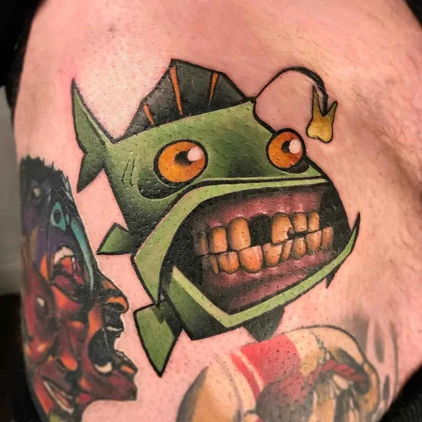 Cartoon Fish tattoo on Thigh