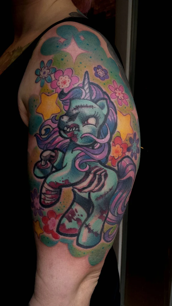 Cartoon Zombie, Unicorn tattoo on Upper Arm
