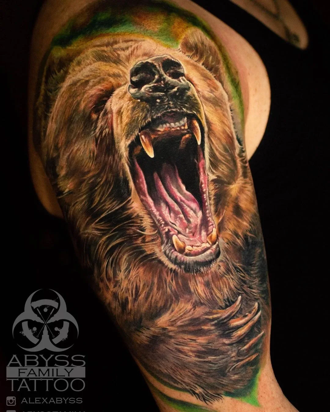 A highly detailed realistic tattoo of a roaring bear's face with impressive shading and colour blending.