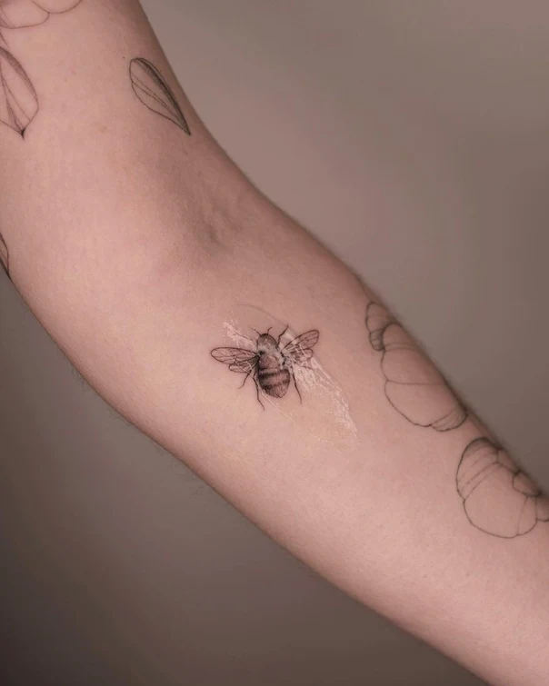 Fineline Bee tattoo on Forearm