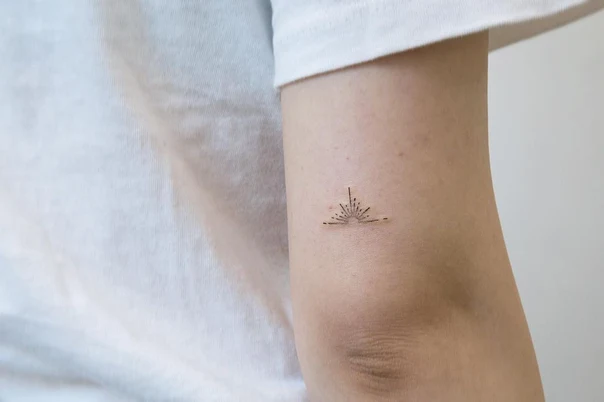 Fineline Sun tattoo on Forearm