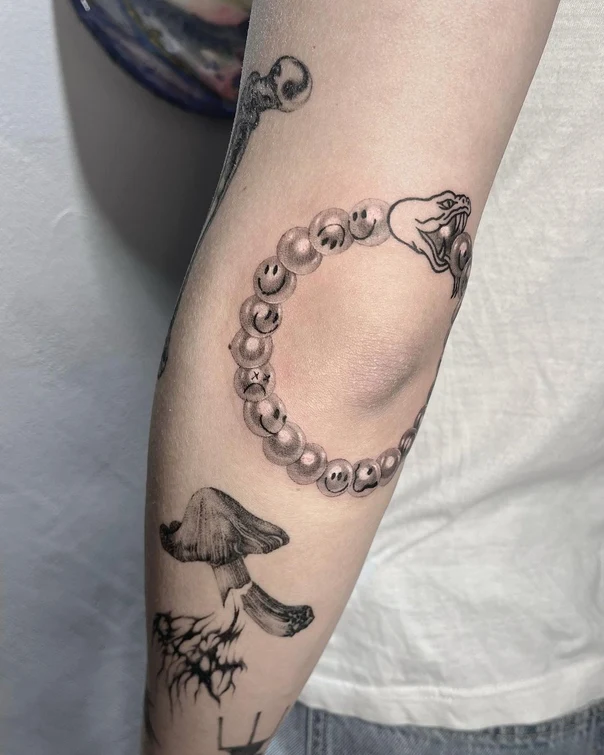 Black & Grey Snake, Smiley face tattoo on Forearm