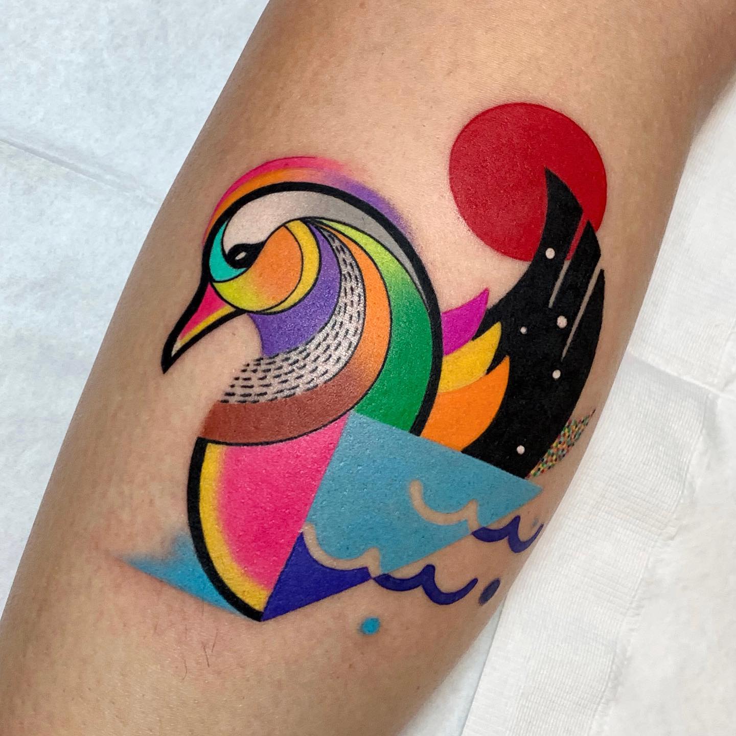 This colorful bird tattoo by Petra works a charm to pull together the  clients existing tattoos | Ratta Tattoo
