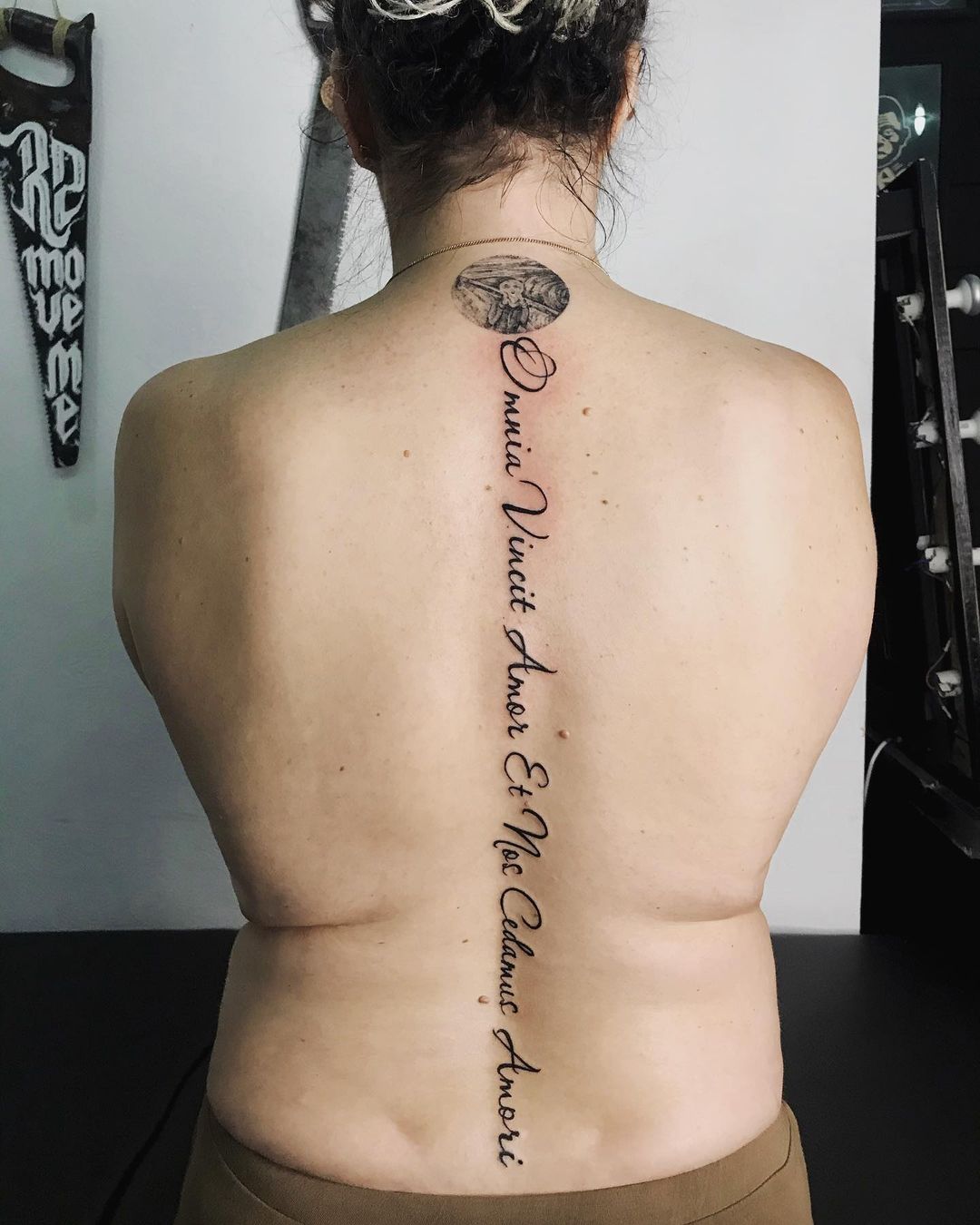 roman numeral spine tattoos