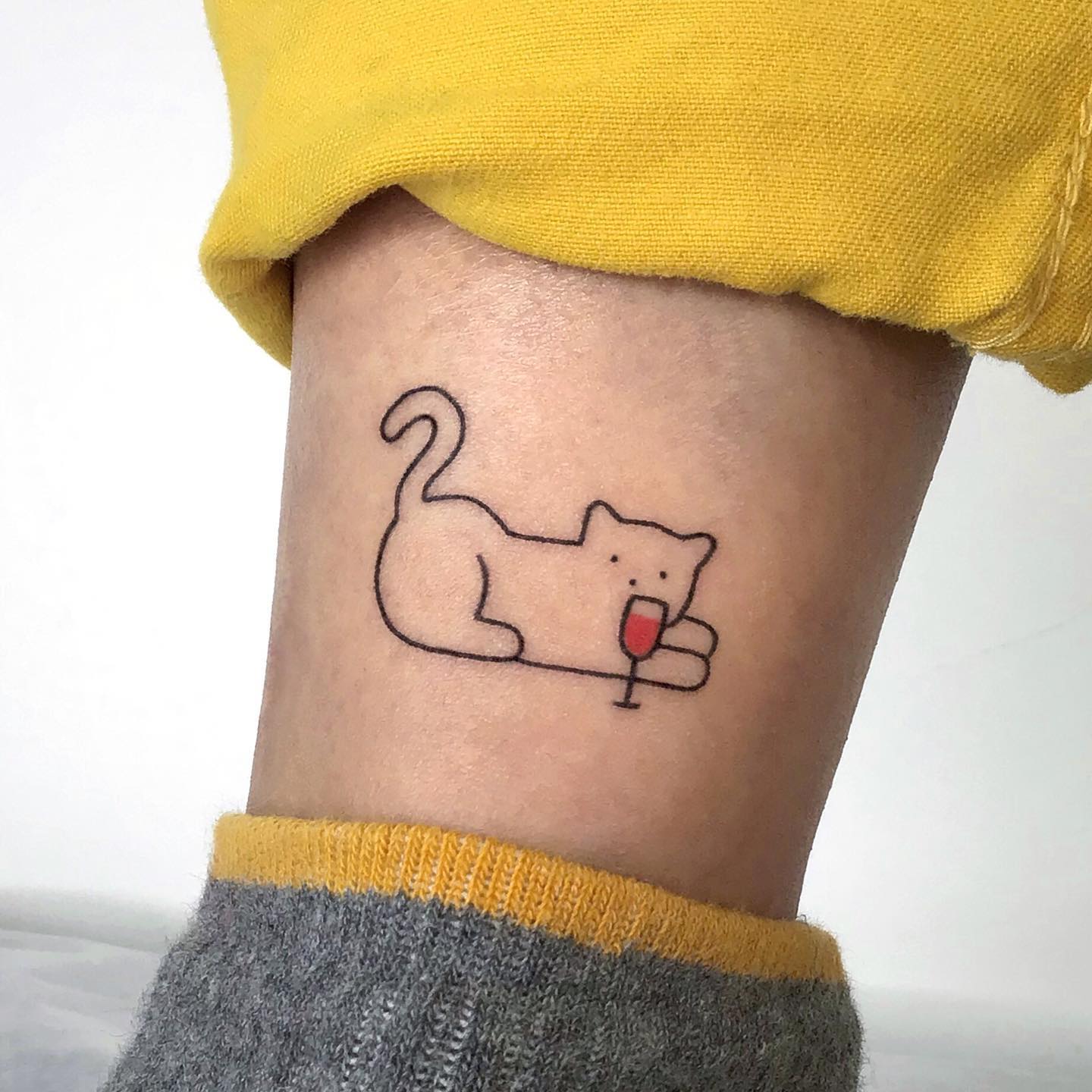 Glass of Wine in Hand Tattoo by Ana Maturana