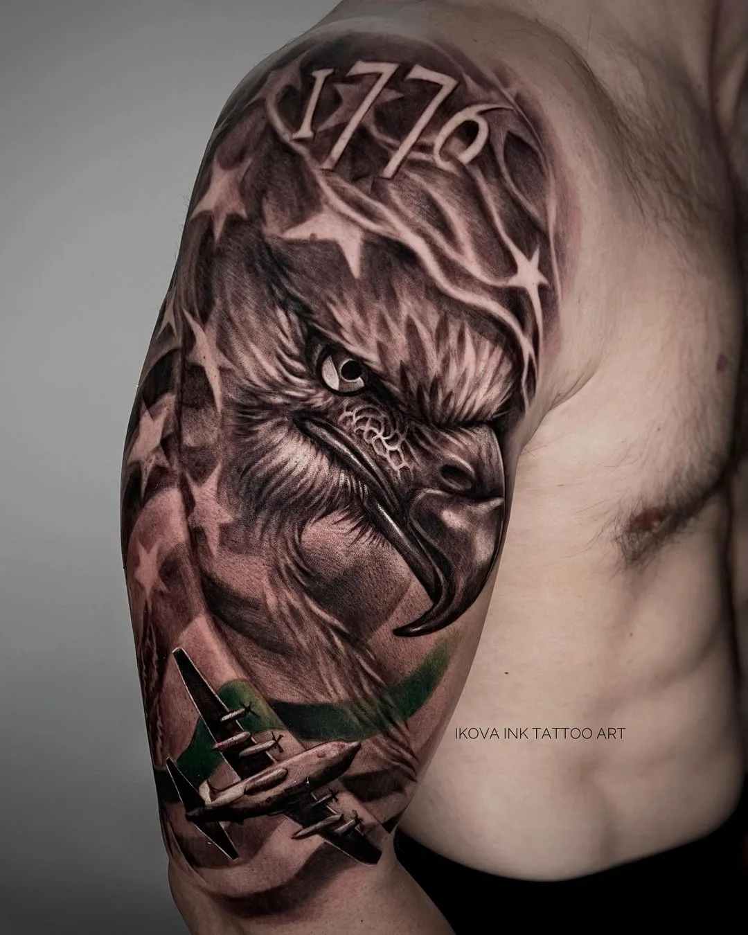 Full sleeve black and grey tattoo featuring an eagle, American flag motifs, and an airplane in detailed linework.