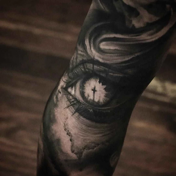 Black & Grey Eye, Cross tattoo on Forearm