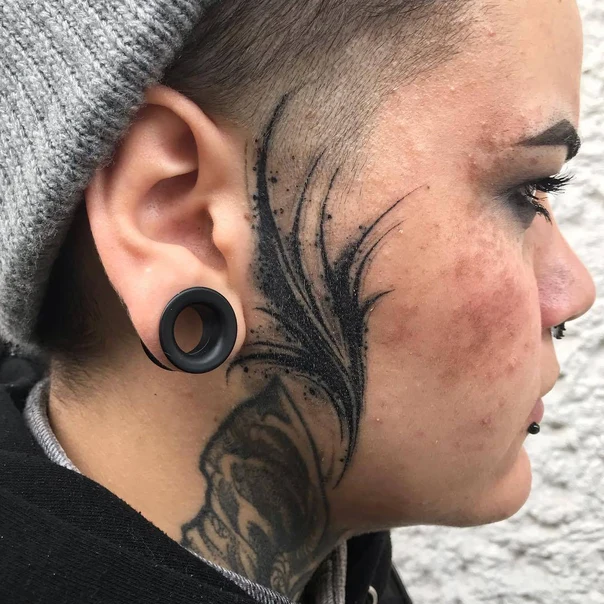 Blackwork Feather tattoo on Face