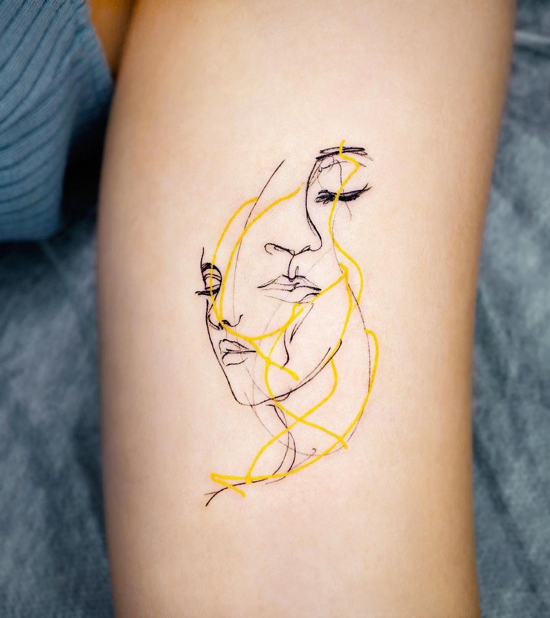 One line face tattooed on the inner forearm