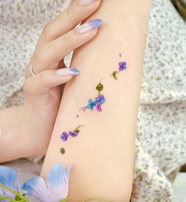 Watercolor Flowers, Leaves tattoo on Forearm