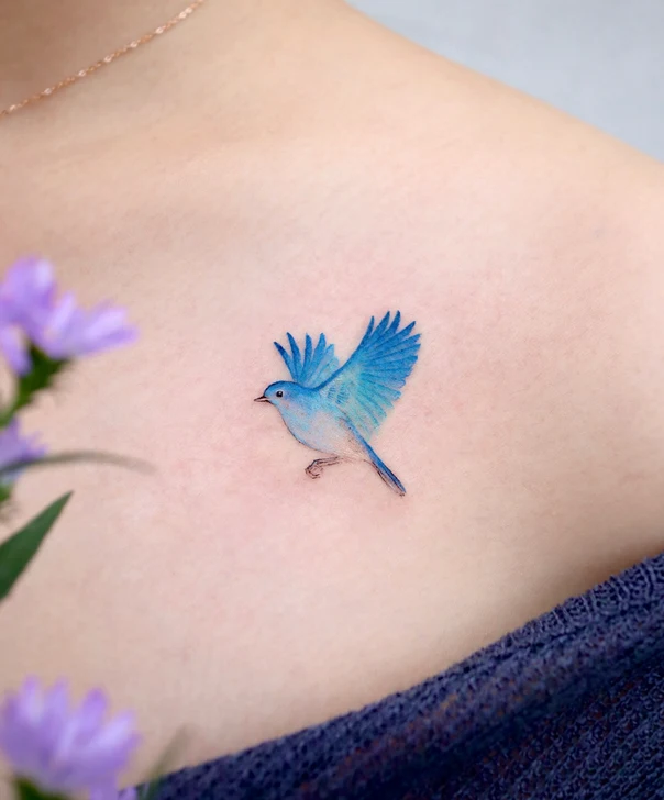 Watercolor Bird tattoo on Collarbone