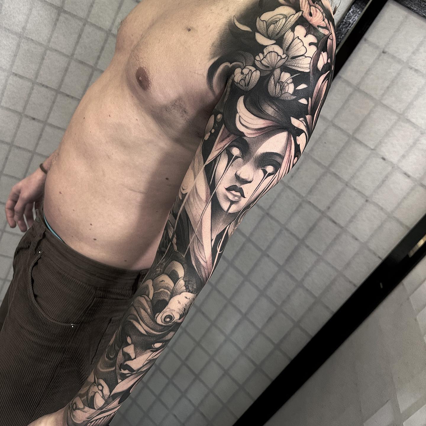 Neo-traditional sleeve tattoo by Kenni Poke