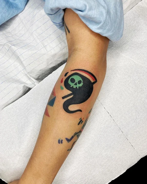 Cartoon Skull, Grim reaper tattoo on Forearm