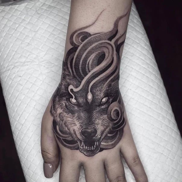 Black & Grey Wolf tattoo on Back of Hand