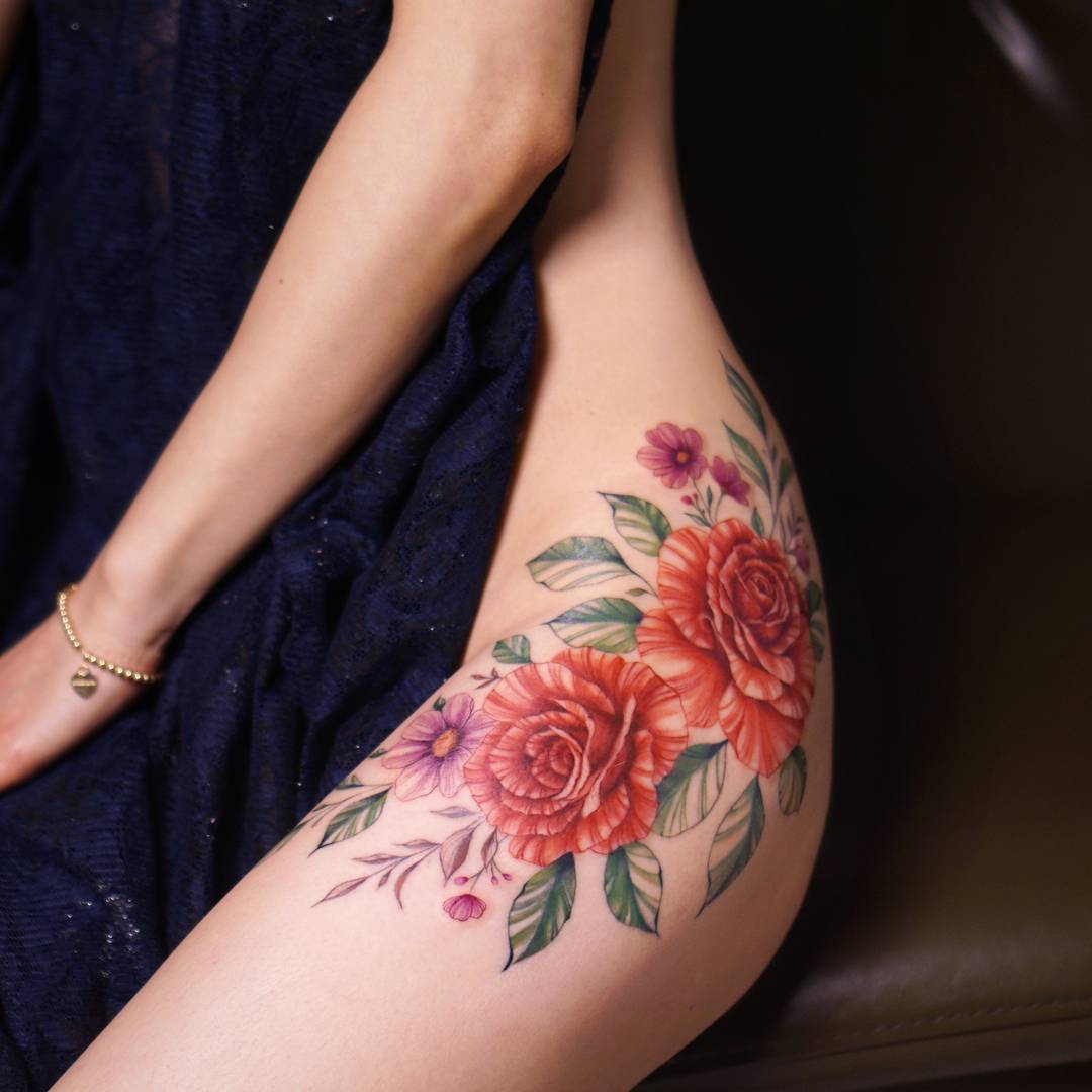 Beautiful floral tattoo on the left hip  Tattoogridnet