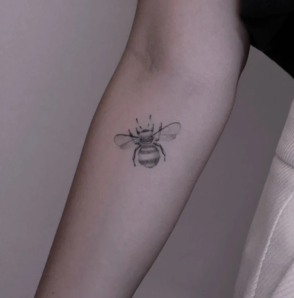 Fineline Bee tattoo on Forearm