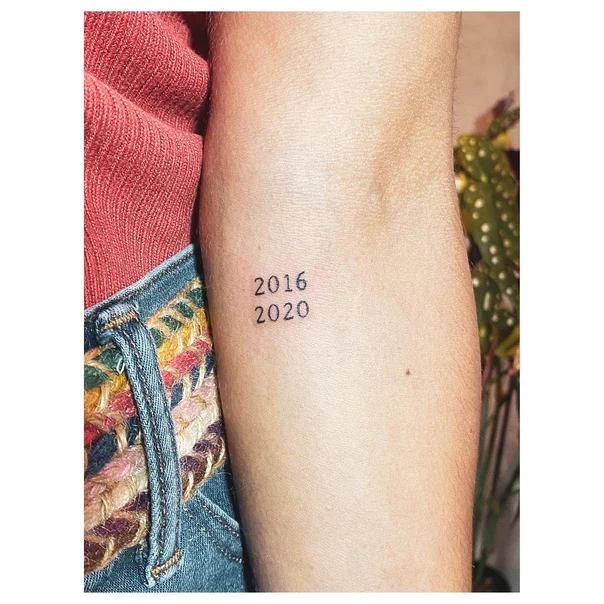 Lettering Numbers tattoo on Forearm
