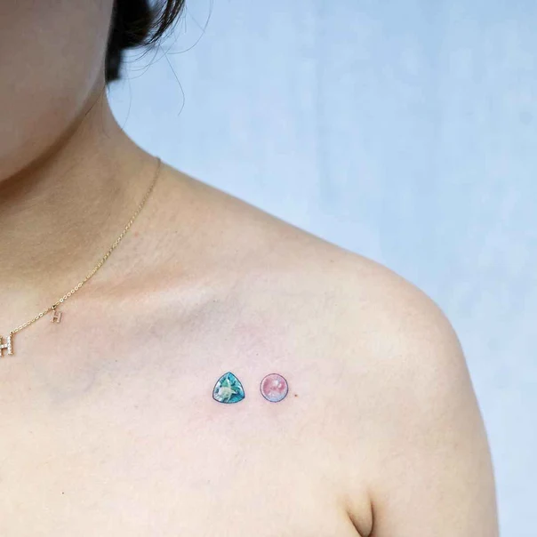 Fineline Gemstone tattoo on Collarbone