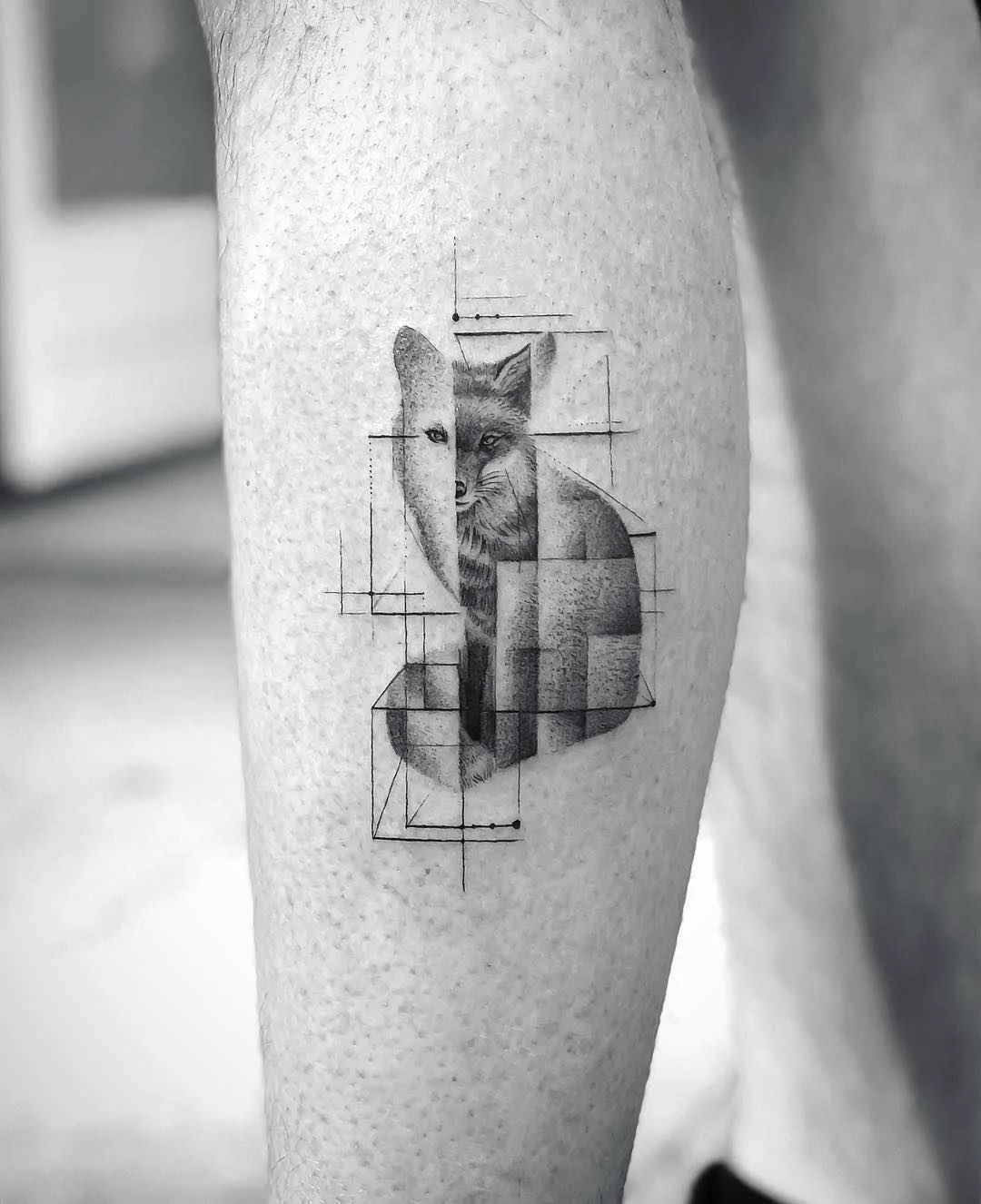A black and grey tattoo of a fox head integrated with geometric shapes, blending realism and abstract angular design.